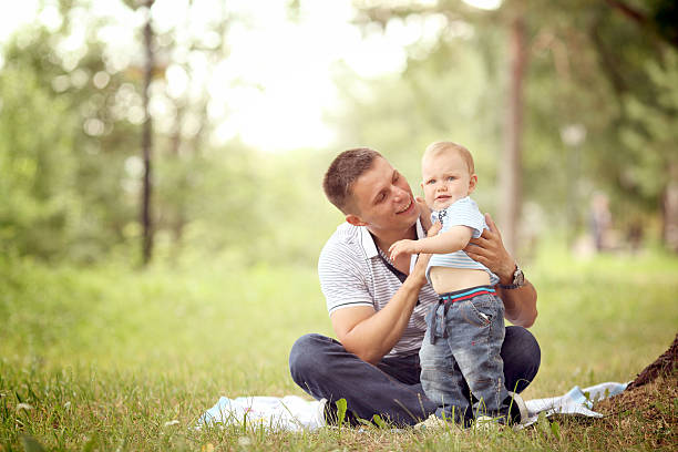 istock little boy playing in the park with dad 467940676