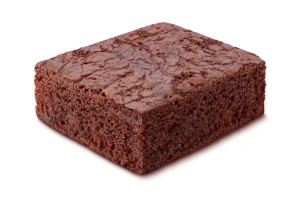  Chocolate Brownie with photographed from an upper angle.  A brownie is a small square of rich baked chocolate cake topped with a crust.  Although high in calories, this food makes an excellent dessert  or snack.  Brownies are very popular during the winter and around Christmas time.  They can be found in the bakery department of the grocery store. The image is shown at an angle, and is in full focus from the front to the back. This is achieved by shooting multiple exposures, and stacking the focused portions. The image is a cut out, and is isolated on a white background.