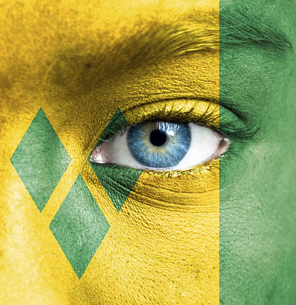 istock Human face painted with flag of Saint Vincent and Grenadines 467943729
