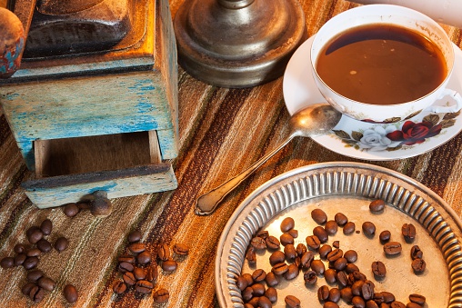coffee background with coffee beans on wooden table and old equipment