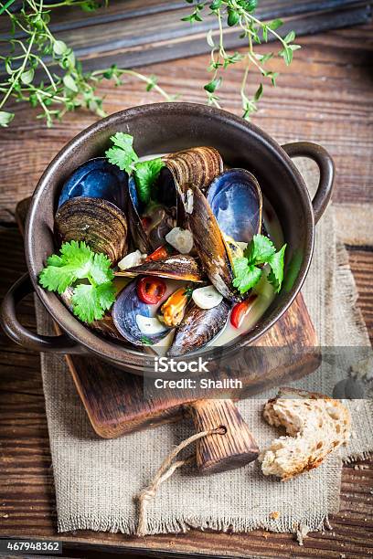 Tasty Mussels With Garlic And Red Peppers Stock Photo - Download Image Now - 2015, Backgrounds, Black Color