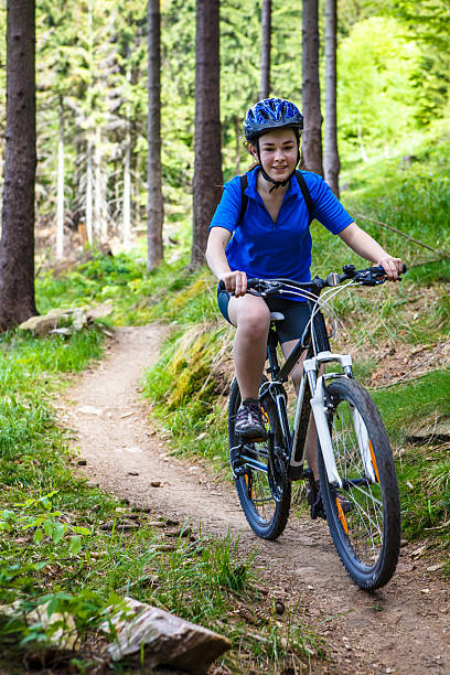 istock Girl riding bike on forest trails 467950961