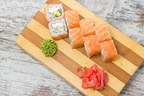 istock Salmon sushi roll on gete over  wooden background 467953172
