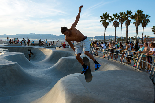 Venice Beach, California, USA - March 14, 2015: An African-American young man skates while listening to music at the Venice Beach Skate Park in Venice Beach, California