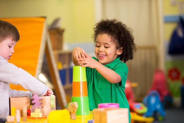 istock Two little boys playing with building blocks in a nursery 467955130