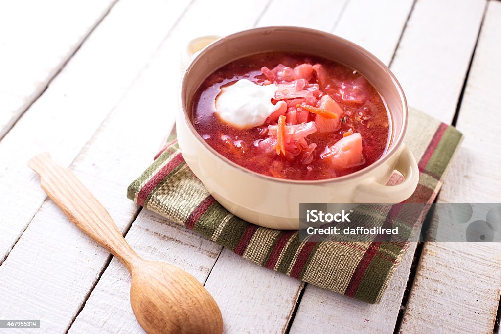 Fresh appetizing vegetable soup Fresh appetizing vegetable soup borsch with potato, carrot, onion, tomato, beetroot in  bowl on table. Selective focus. 2015 Stock Photo