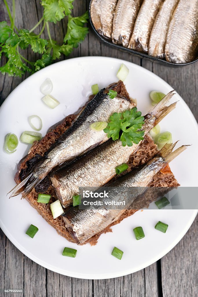 Sandwich with sprats on wooden table Sandwich with sprats on wooden table, close up, top view Canned Food Stock Photo