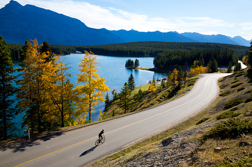 A woman enjoys an afternoon road bicycle ride on a sunny day in October.