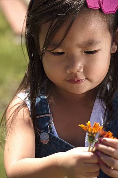 istock Asian female toddler with flower 467971902