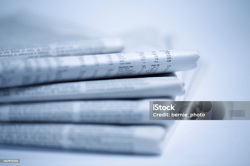 newspaper isolated on white background newspapers against plain background shot with very shallow depth of field - Blue tone Blue Stock Photo