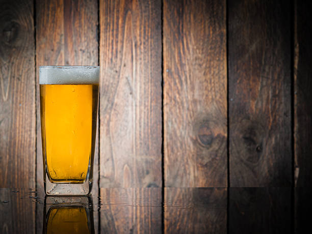 istock Glass beer on wood background with copyspace 467973062