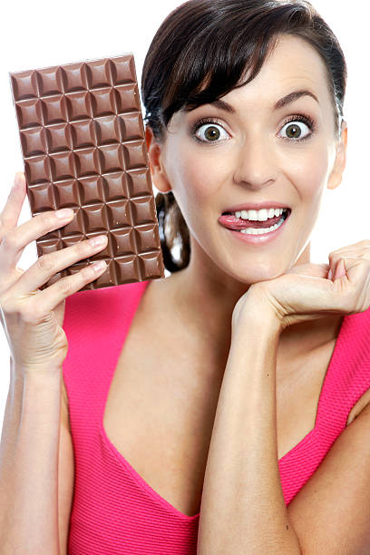 istock Woman eating chocolate bar 467976234
