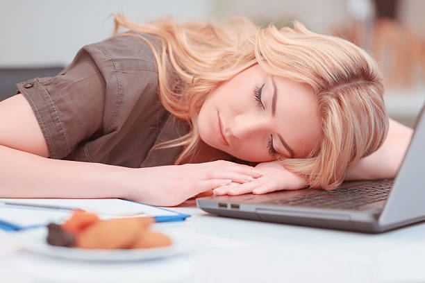 istock Beautiful young woman sleeping in the office 467976404