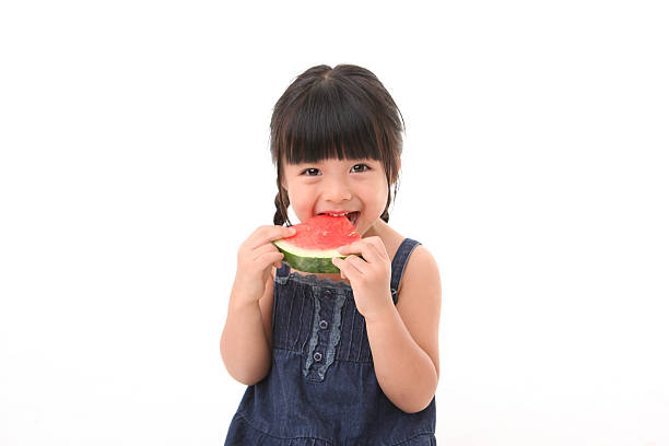 menina comer melancia - isolated isolated on white studio shot food imagens e fotografias de stock