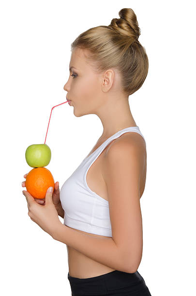 bela mulher beber suco de frutas - isolated on white fun orange food - fotografias e filmes do acervo