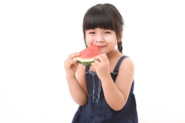 istock Little girl eating water melon 467978578