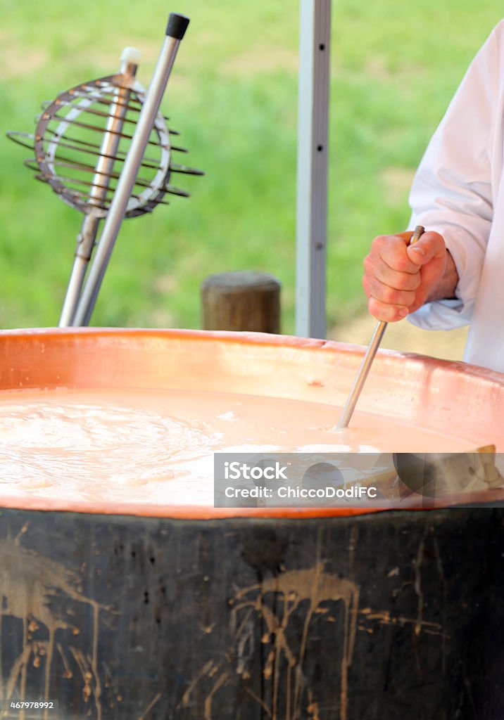 copper pot with milk for making cheese copper pot with boiling milk for making cheese in the mountain dairy 2015 Stock Photo