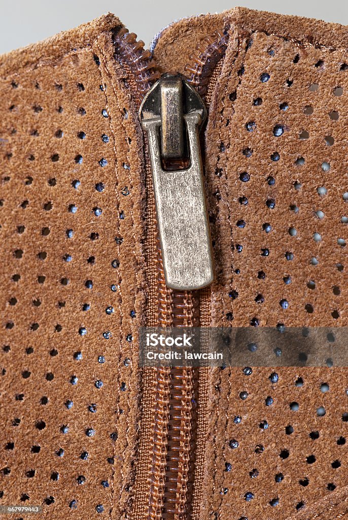 Boot Zipper in Perforated Suede Close up of zipper in perforated suede boot. Animal Stock Photo