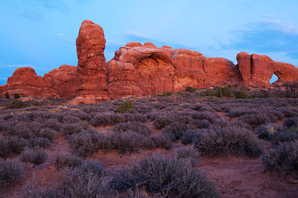 istock Window Arch and red rocks formation at twilight 467982107
