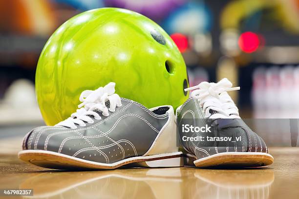 Closeup Of Bowling Shoes And Neon Green Ball Stock Photo