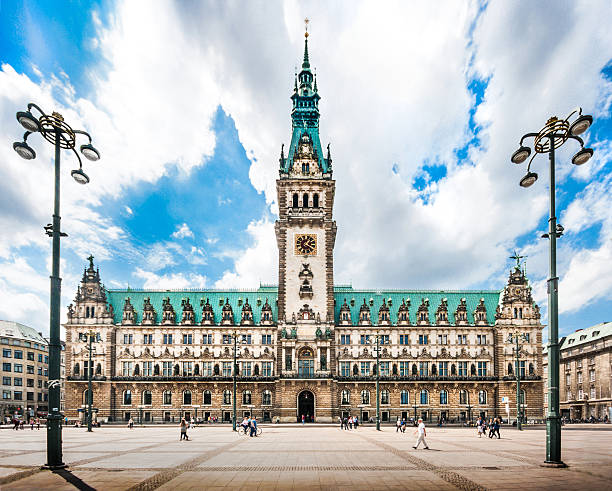 Hamburg town hall with dramatic clouds, Germany Beautiful view of famous Hamburg town hall with dramatic clouds and blue sky at market square near lake Binnenalster in Altstadt quarter, Hamburg, Germany. binnenalster lake stock pictures, royalty-free photos & images