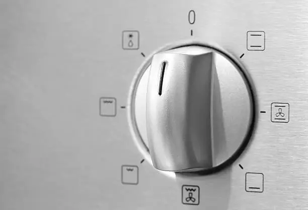Metallic Toggle Switch of Cooker Oven. Close-up View