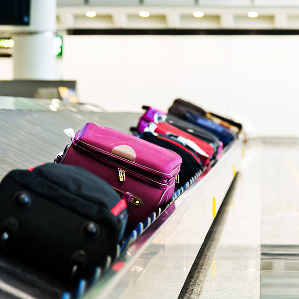 istock Luggage on belt at baggage claim 467990296