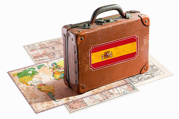 istock Antique leather suitcase with Spain flag on maps 467997583