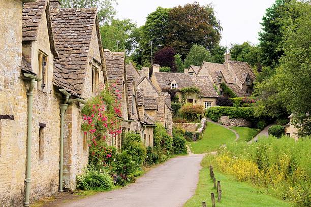 Stone houses of the English Cotswolds Picturesque old stone houses of Arlington Row in the village of Bibury, England  gloucestershire stock pictures, royalty-free photos & images