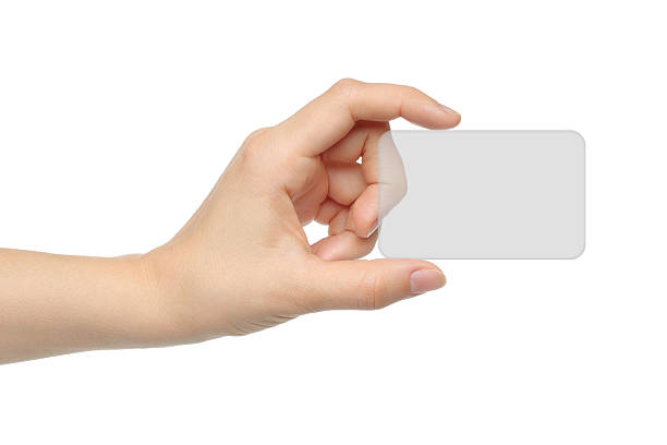 A hand holding a transparent charge Card  stock photo