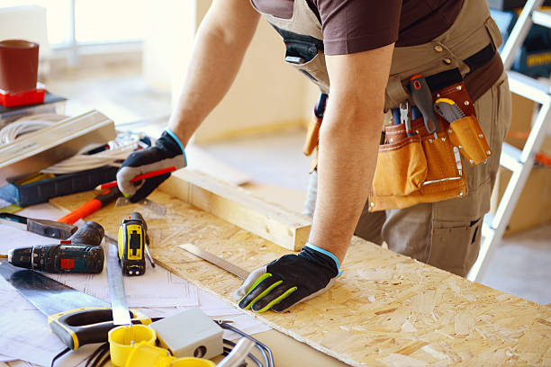 istock Carpenter wearing a tool belt and measuring wood to cut 467999932