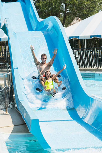 istock Father and daughter on water slide 468000122