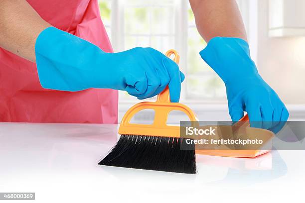 Hand With Glove Using Cleaning Broom To Clean Up Stock Photo - Download Image Now - Dustpan, Antiseptic, Broom