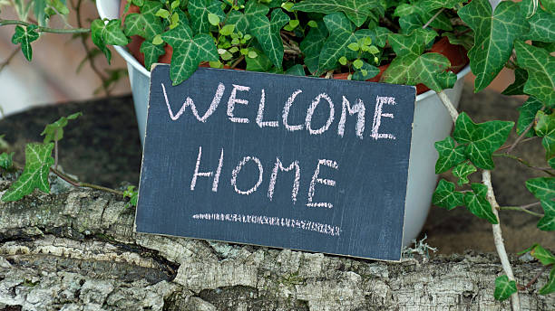 Welcome home written Welcome home written on a chalkboard in a garden homeward stock pictures, royalty-free photos & images