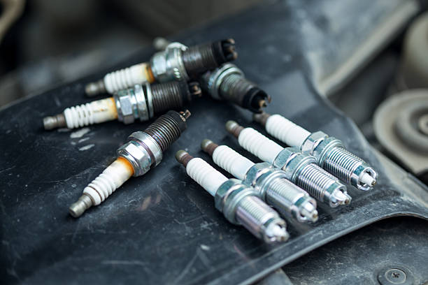 Worn and new spark plugs stock photo