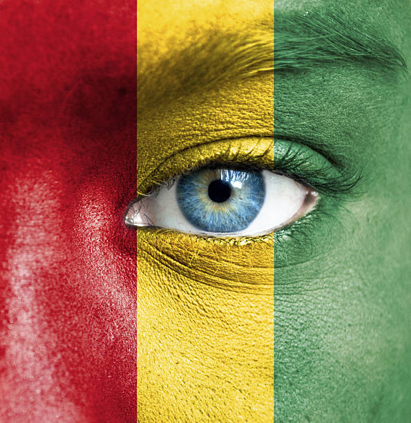 istock Human face painted with flag of Guinea 468004253