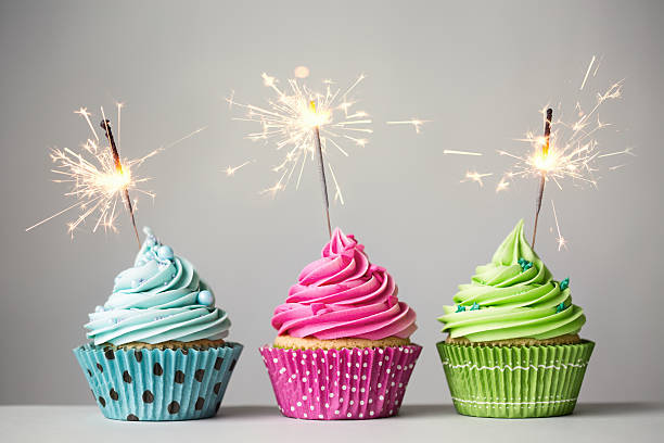 Three cupcakes with sparklers Row of three cupcakes with sparklers birthday cake photos stock pictures, royalty-free photos & images