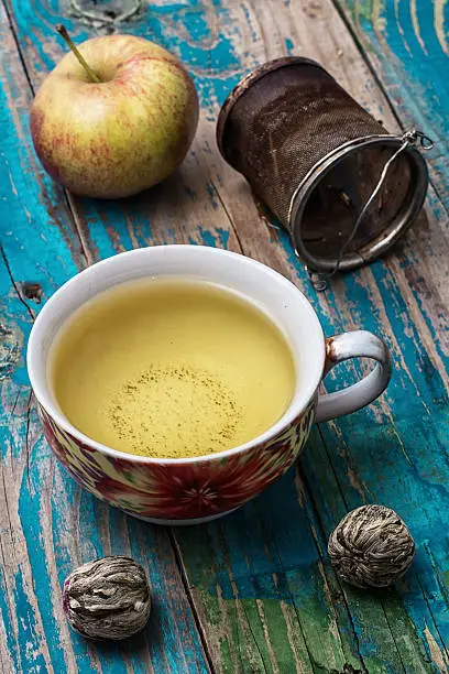 Cup of brewed tea.welding and ripe apple on new background