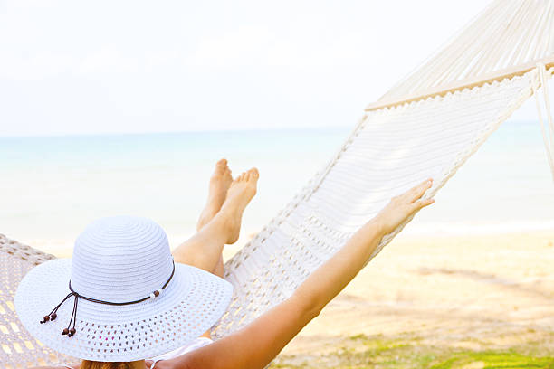 istock Young woman relaxing on hammock at seaside 468030431