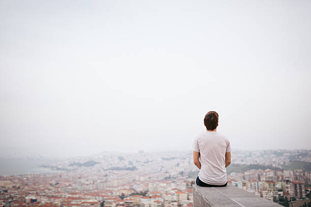 istock Young man sitting with cityscape 468039522