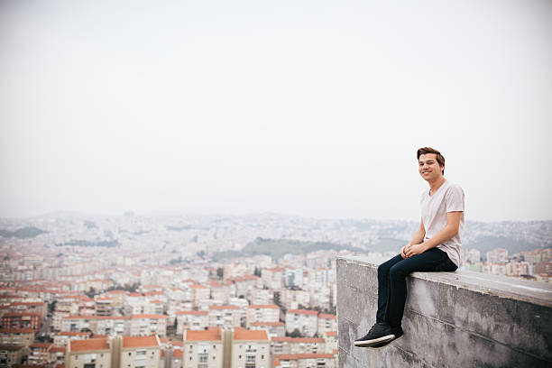 istock Young man sitting with cityscape 468039528