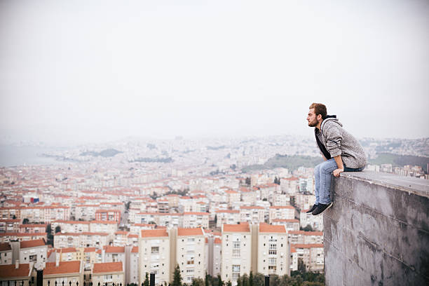 istock Young man sitting with cityscape 468039570