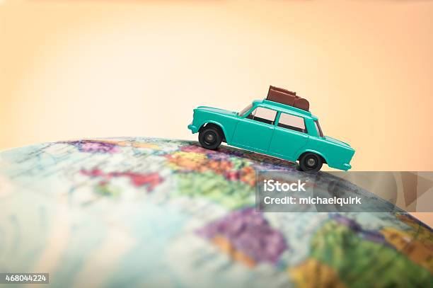 Vacationing Toy Car On A Globe Stock Photo - Download Image Now - Car, Globe - Navigational Equipment, Leaving