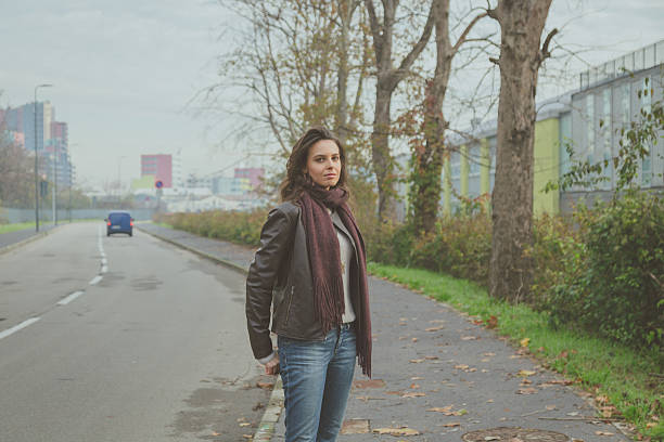 istock Beautiful young brunette posing in the city streets 468044800