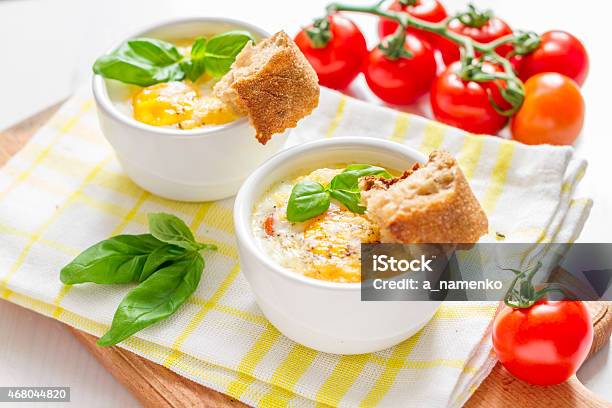 Egg Cocotte With Cherry Tomatoes In White Ramekins Bread Stock Photo - Download Image Now