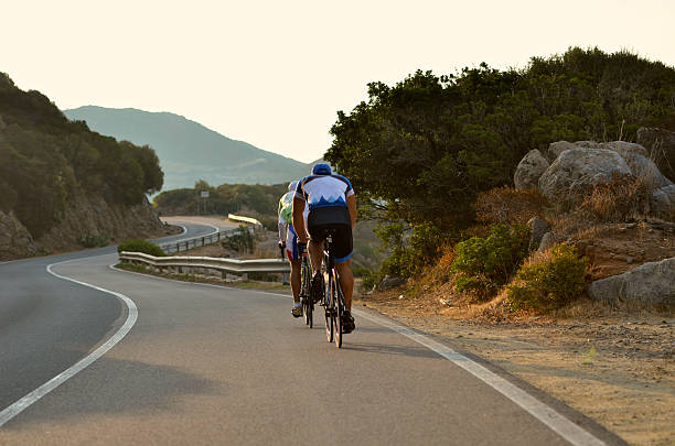 istock two cyclists train at dawn between the curves from behind 468048058