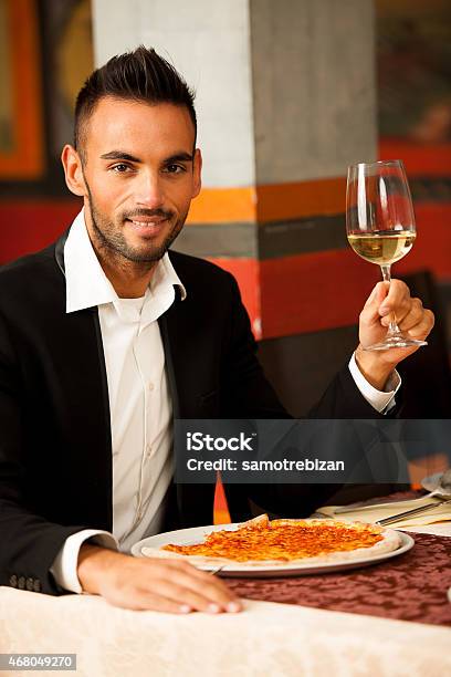 Handsome Man Eating Pizza In Restaurant Stock Photo - Download Image Now - 2015, Adult, Alcohol - Drink