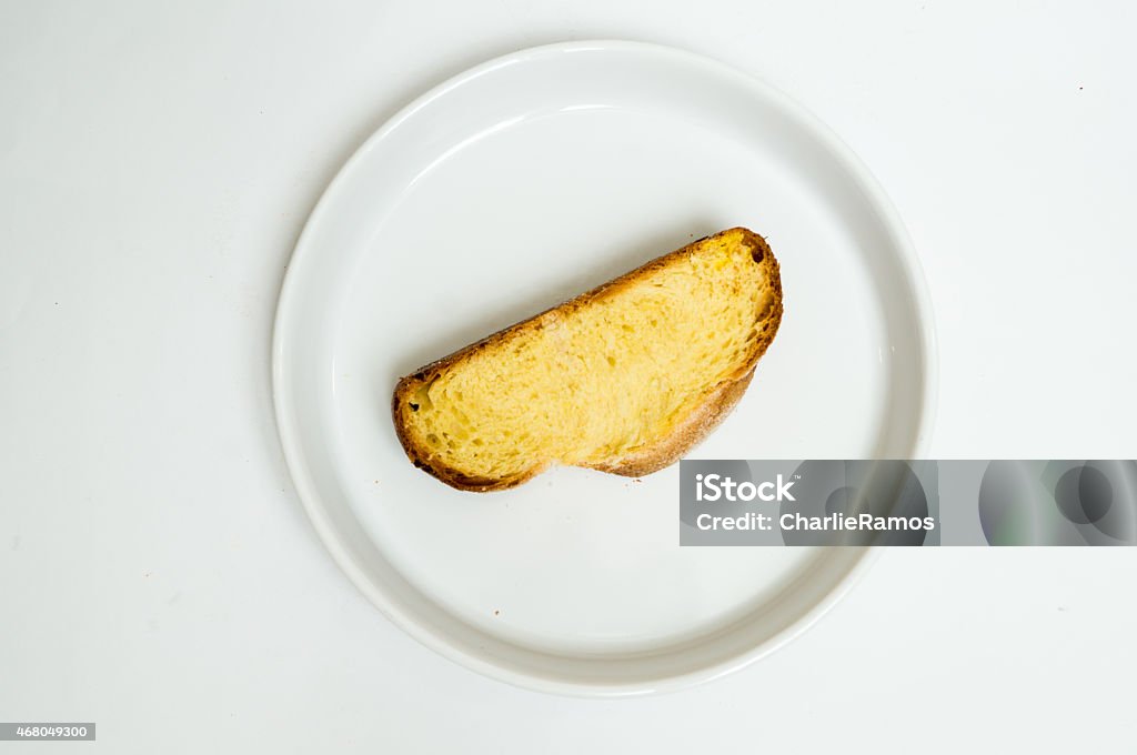 Sweet Bread slice served in a dish. Isolated studio Sweet Bread. Pan dulce with knife. Isolated studio. This kind of bisquit is called in México Pan de Riñón. It is used to cook " Torrejas ", " torrijas "  or French Bread. 2015 Stock Photo