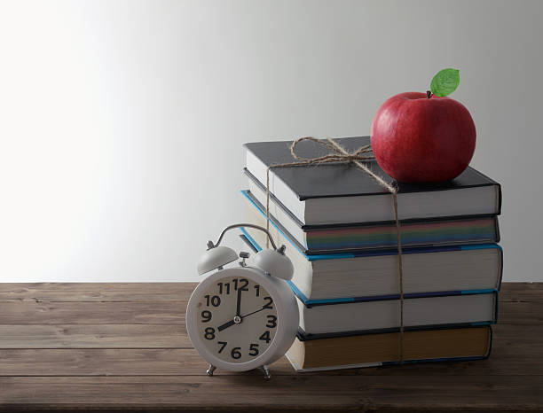 istock books with alarm and red Apple 468050542
