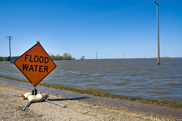 Flood Water - Red River, Manitoba A sign warns of flood waters near Rapid City, Manitoba. creighton stock pictures, royalty-free photos & images